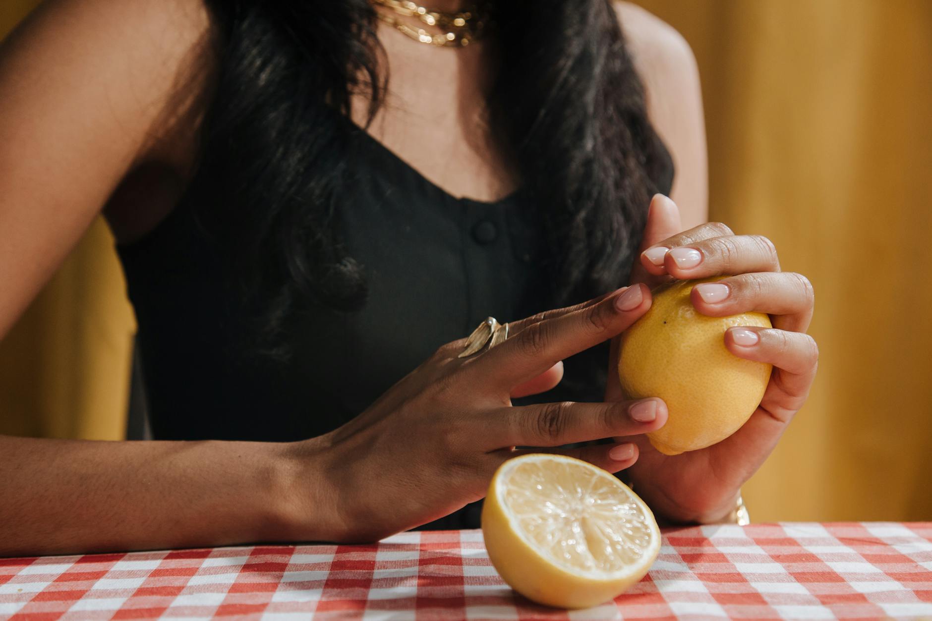 Two women smiling together with fresh lemons, expressing joy and comfort
