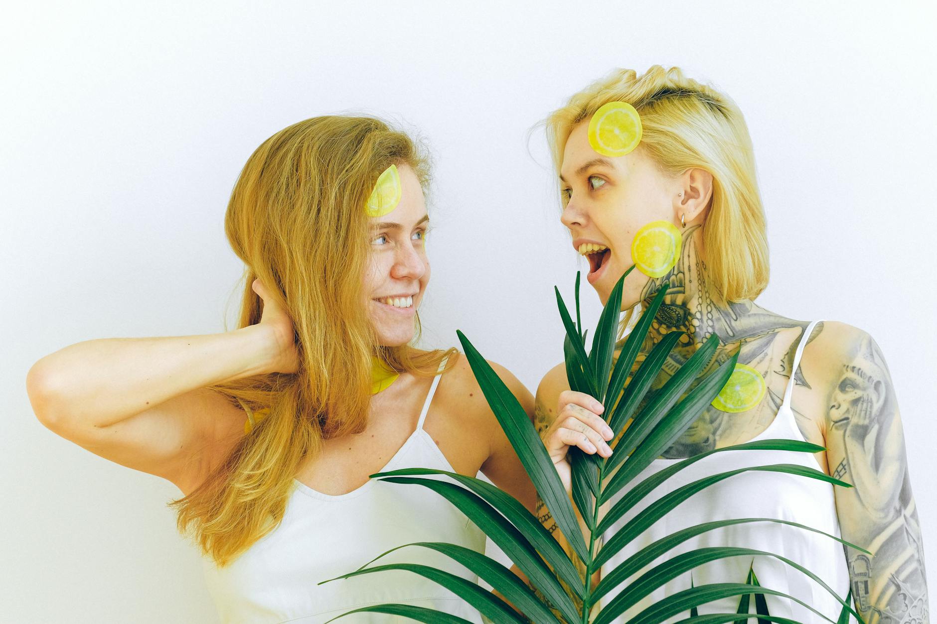 Yellow silicone vibrator surrounded by fresh bananas on bright yellow background
