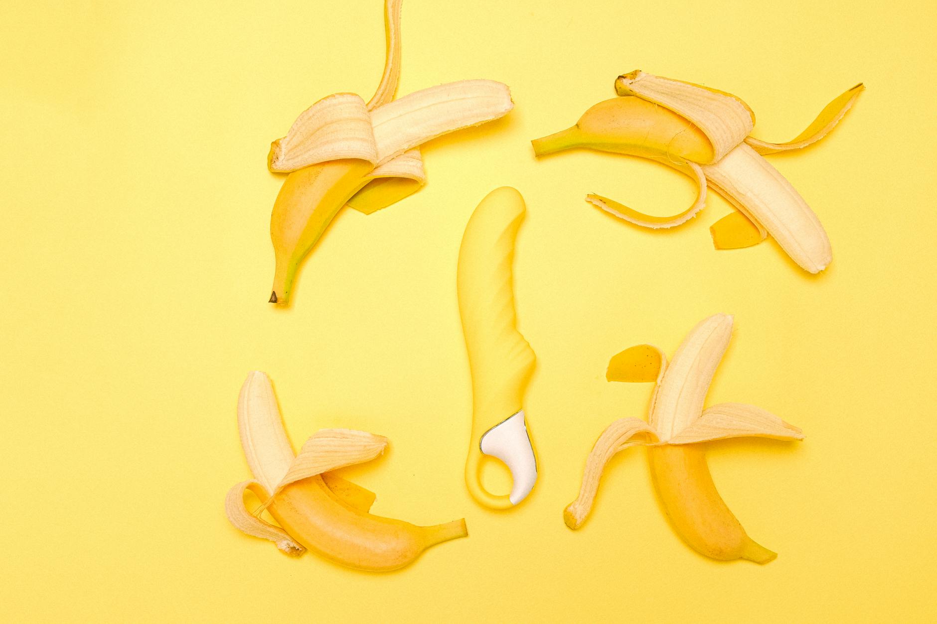 Yellow lemon clitoral vibrator displayed on a minimalist background