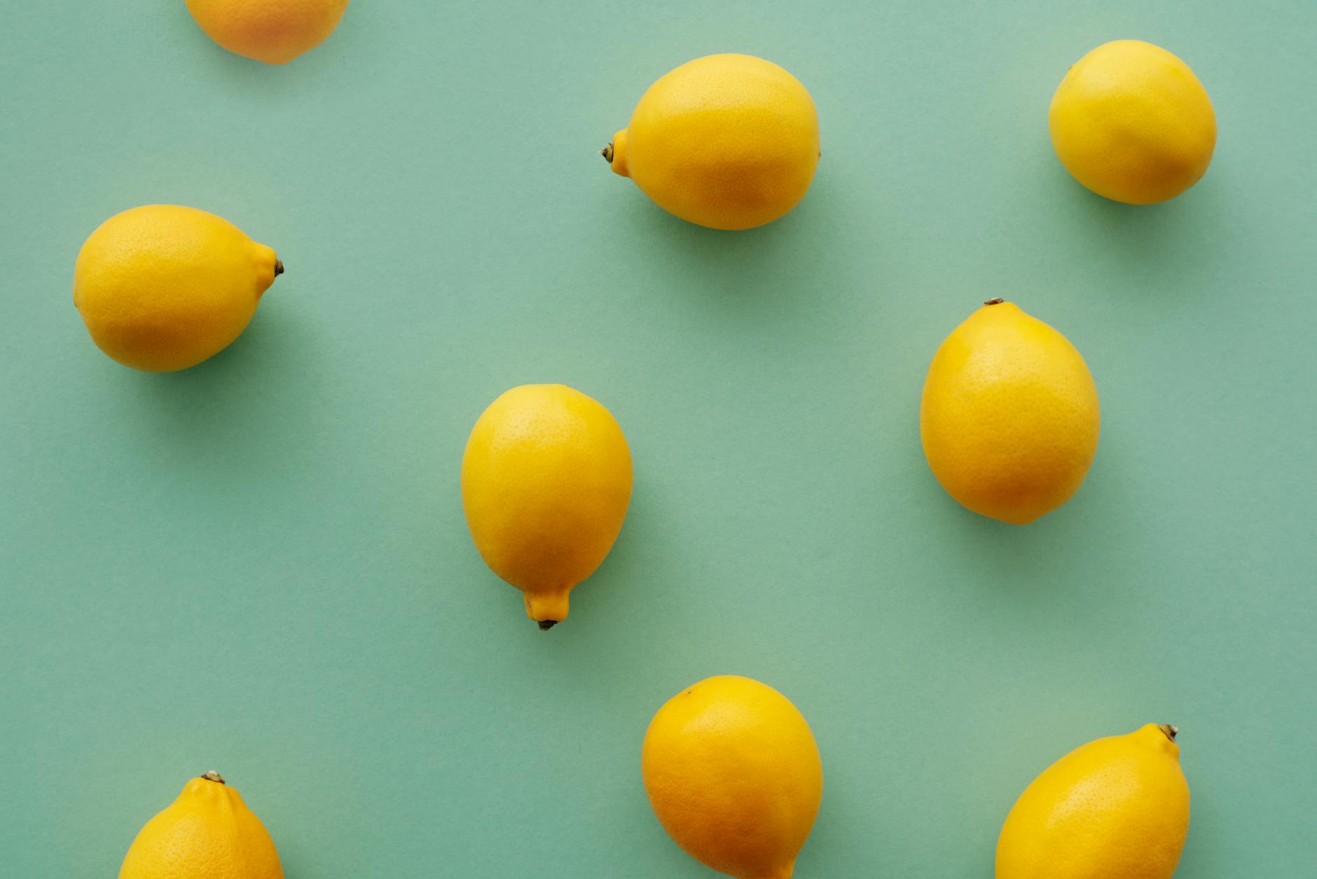 Bright yellow lemons arranged on a pastel background, representing the peak sensitivity of ovulation