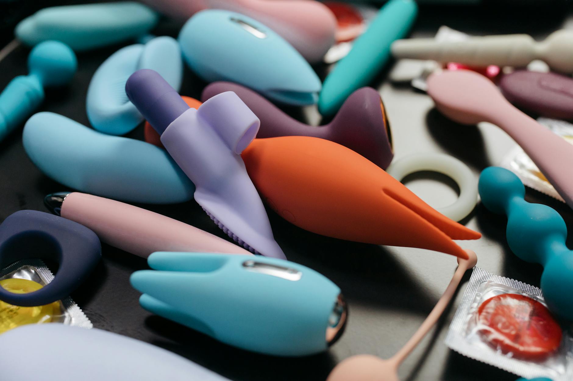An array of vibrant adult toys including lemon-shaped vibrators in a close-up view.